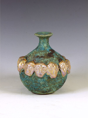 Artist: Beatrice Wood, Title: Blue Lava Galzed Bottle with Ring of Gold Masks, c. 1993 - click for larger image